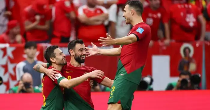 Raphael Guerreiro, Bruno Fernandes, Diogo Dalot of Portugal celebrate a goal at the 2022 World Cup