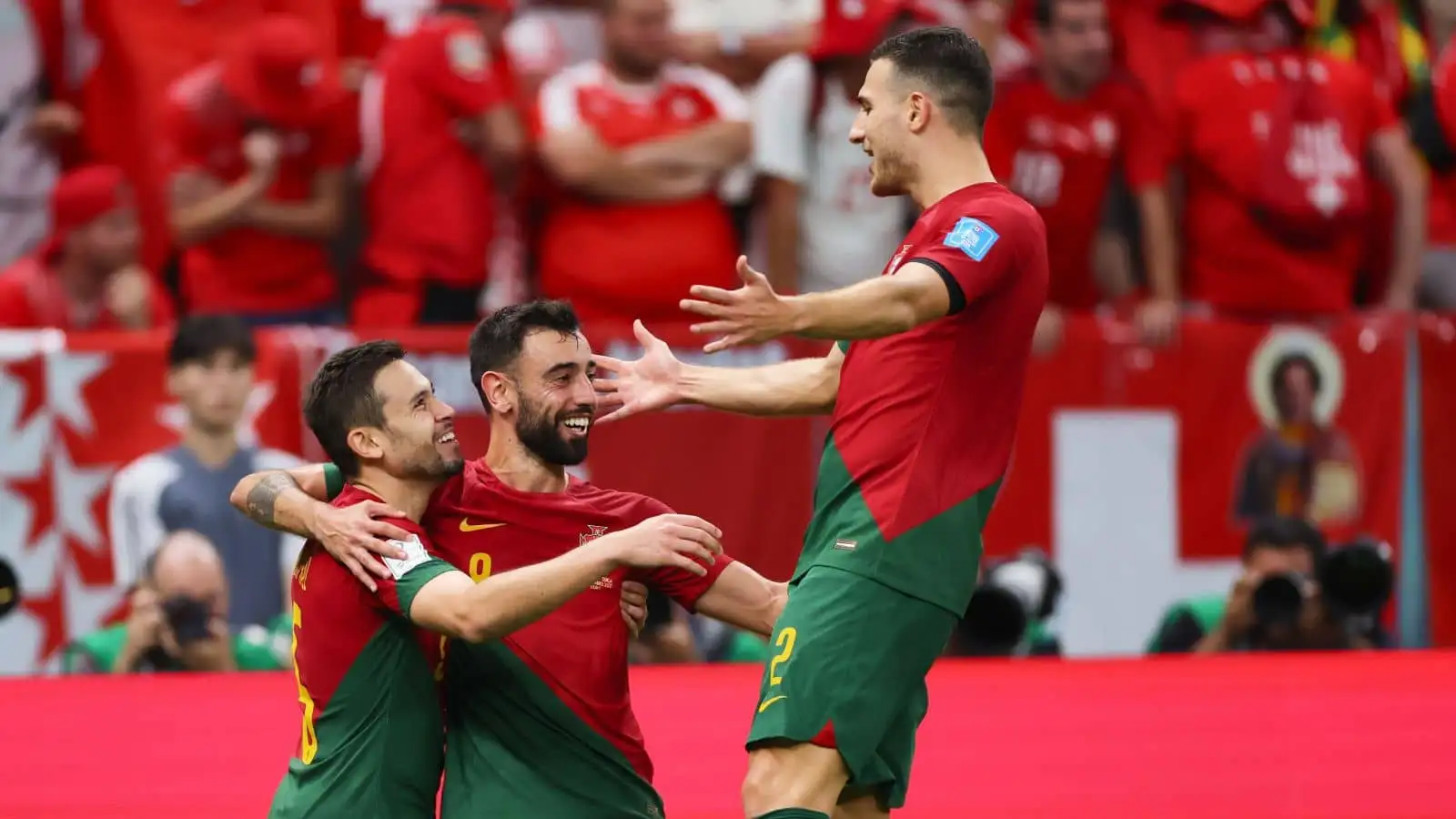 Raphael Guerreiro, Bruno Fernandes, Diogo Dalot of Portugal celebrate a goal at the 2022 World Cup