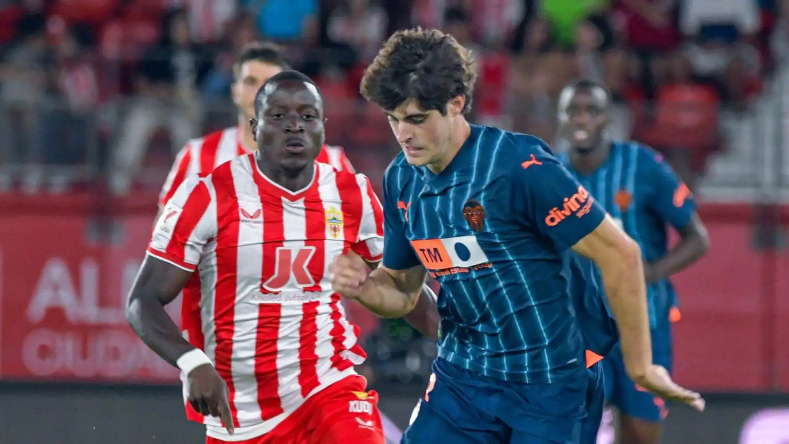 Almeria's Dion Lopy chasing Valencia midfielder Javi Guerra