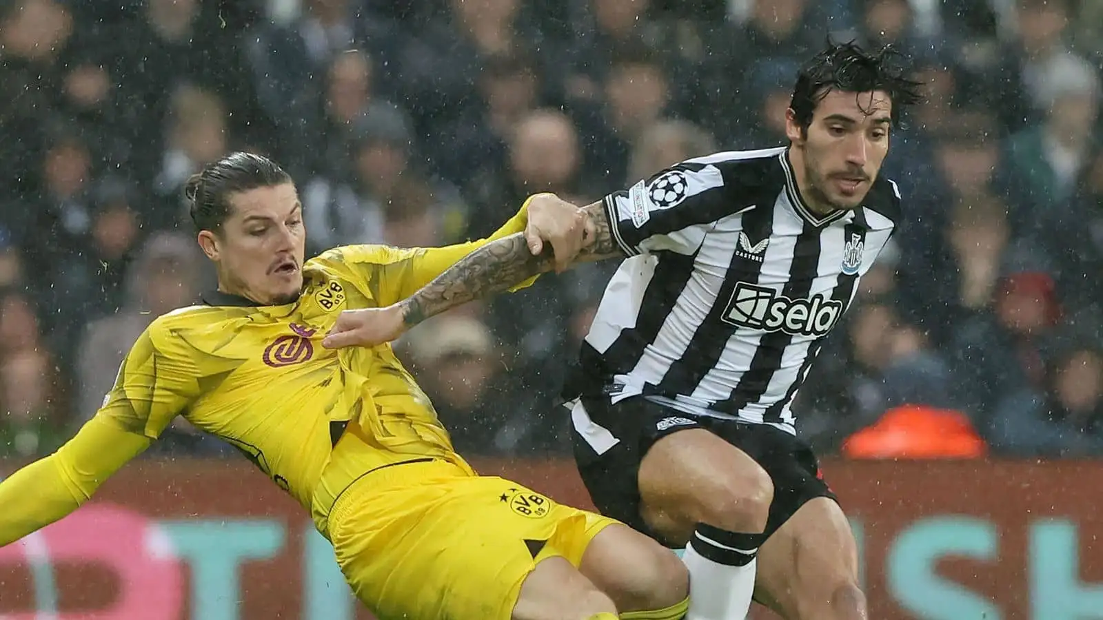 Sandro Tonali of Newcastle United in action with Marcel Sabitzer of Borussia Dortmund during the UEFA Champions League match at St. James' Park, Newcastle Upon Tyne