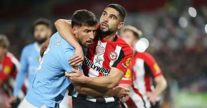 Brentford striker Neal Maupay (on loan from Everton) wrestles with Ruben Dias of Man City