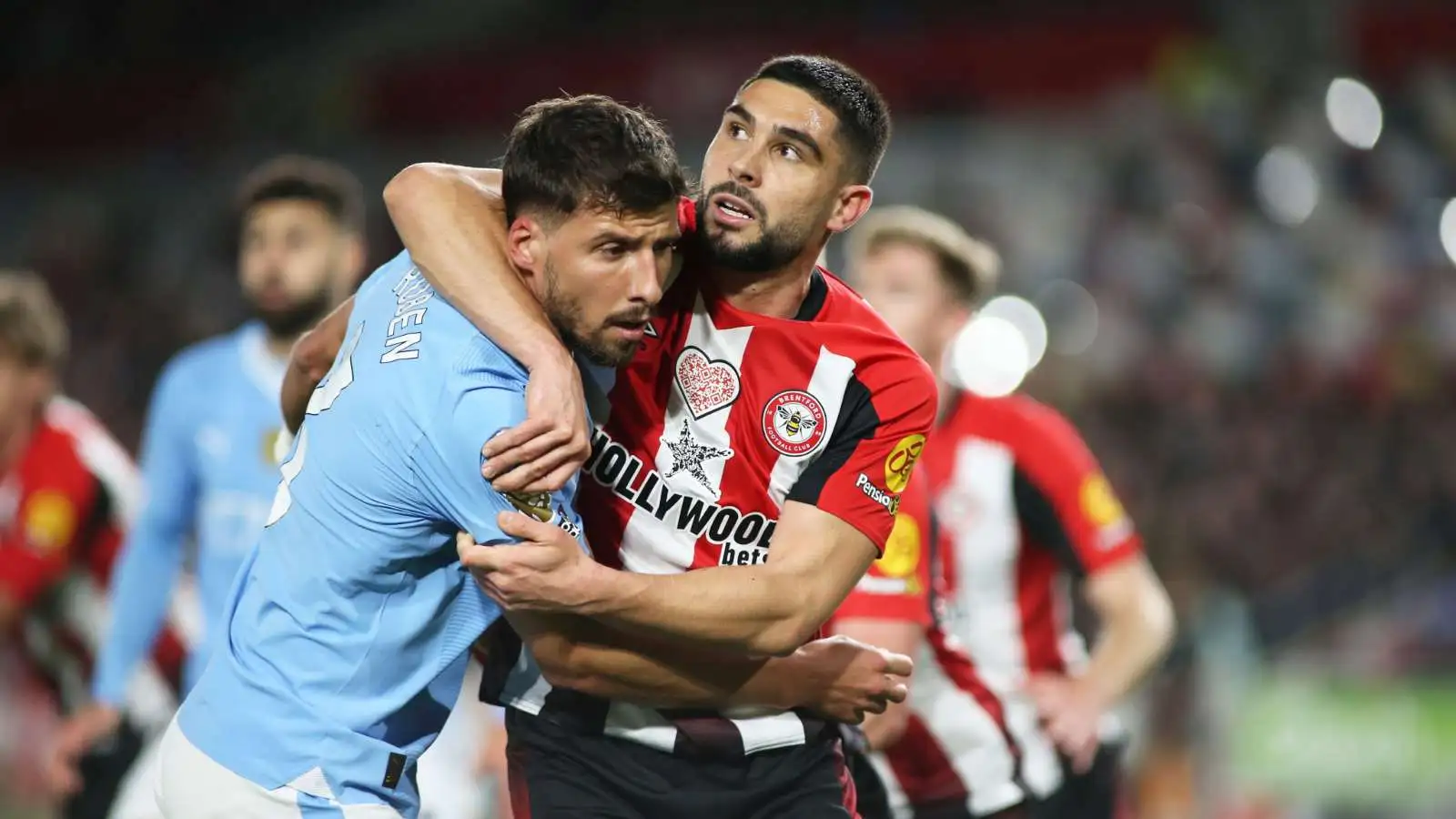 Brentford striker Neal Maupay (on loan from Everton) wrestles with Ruben Dias of Man City