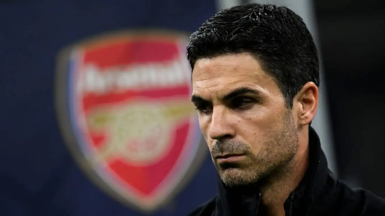 Arsenal manager Mikel Arteta Arsenal manager Mikel Arteta standing in front of the Arsenal club crest