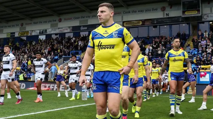 George Williams leads Warrington Wolves out ahead of a Super League game in 2025