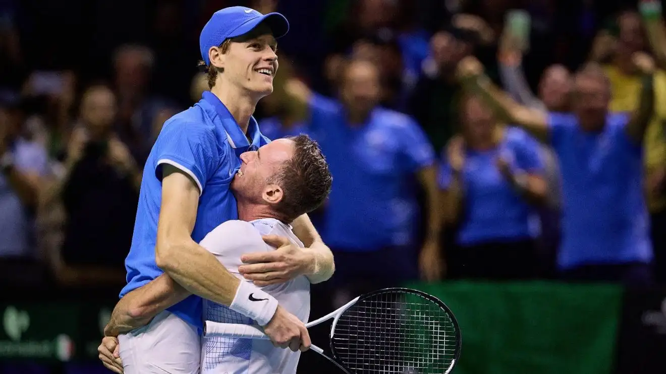 Jannik Sinner and Italy Davis Cup captain Filippo Volandri celebrate.