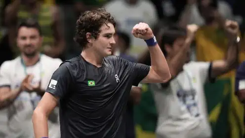 Joao Fonseca fistpumps after winning a match.