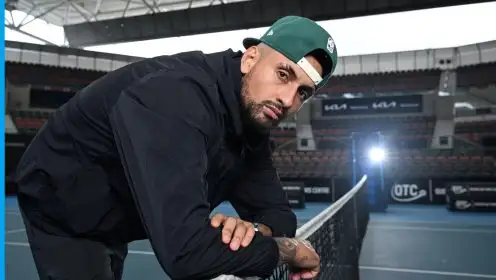 Nick Kyrgios leaning on a net