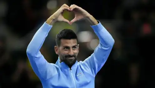 Novak Djokovic gestures to the crowd