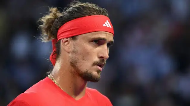 Alexander Zverev looks on.