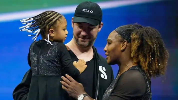 Serena Williams embracing her daughter and husband