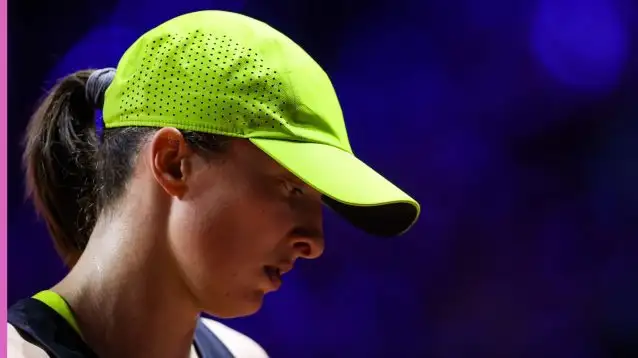 Iga Swiatek looks on.