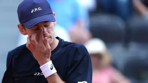 Alex de Minaur with hand on his face