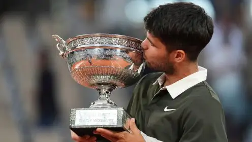 Pictured: Carlos Alcaraz kisses the French Open trophy.