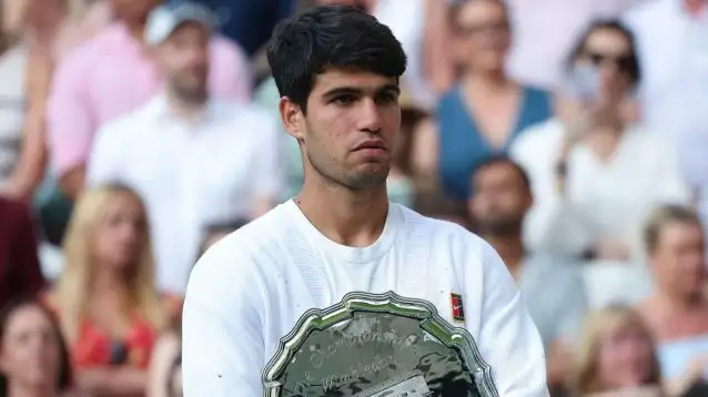 Pictured: Carlos Alcaraz holds the Wimbledon runner-up trophy